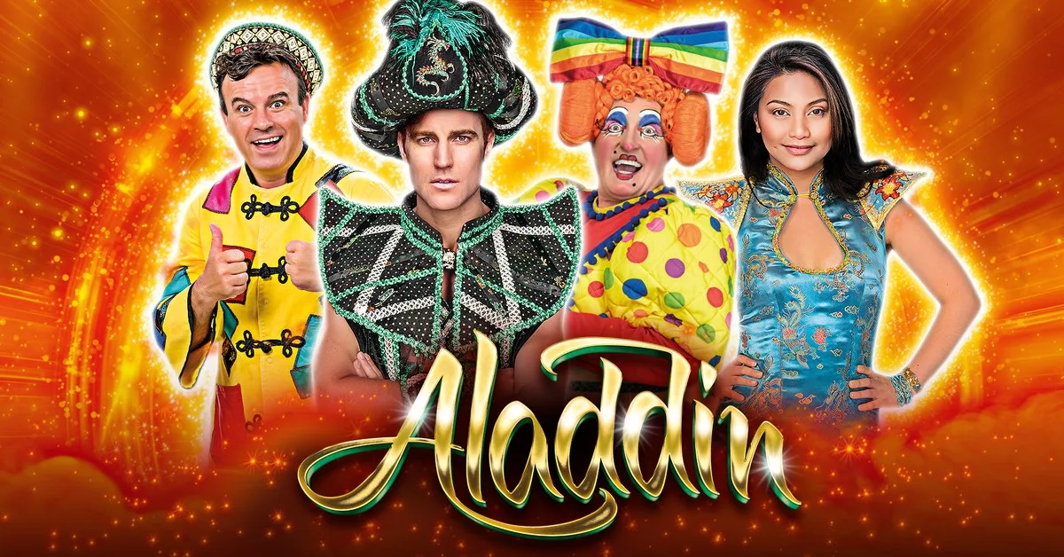 Pantomime artwork showing four costumed cast members, including a dame in a rainbow bow and a villain in a dark turban, behind a gold Aladdin logo