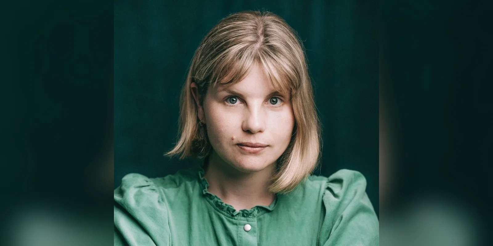 Headshot of actor Elin Phillips in a green blouse