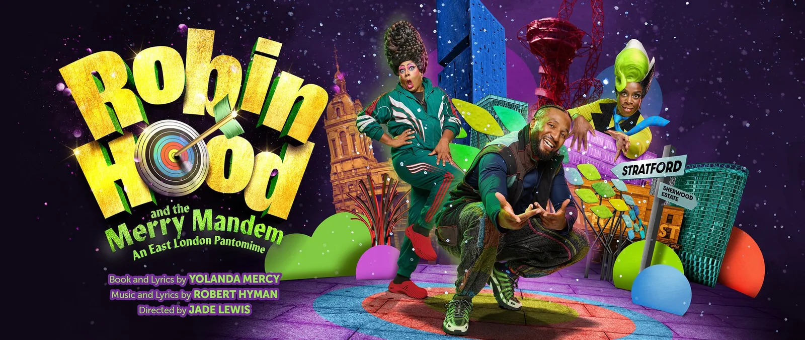 Robin Hood and the Merry Mandem key art for Theatre Royal Stratford East: a smiling performer in a tracksuit and trainers crouches on a target-painted pavement, flanked by two pantomime characters in towering wigs, in front of a colourful East London skyline with a signpost reading Stratford and Sherwood Estate