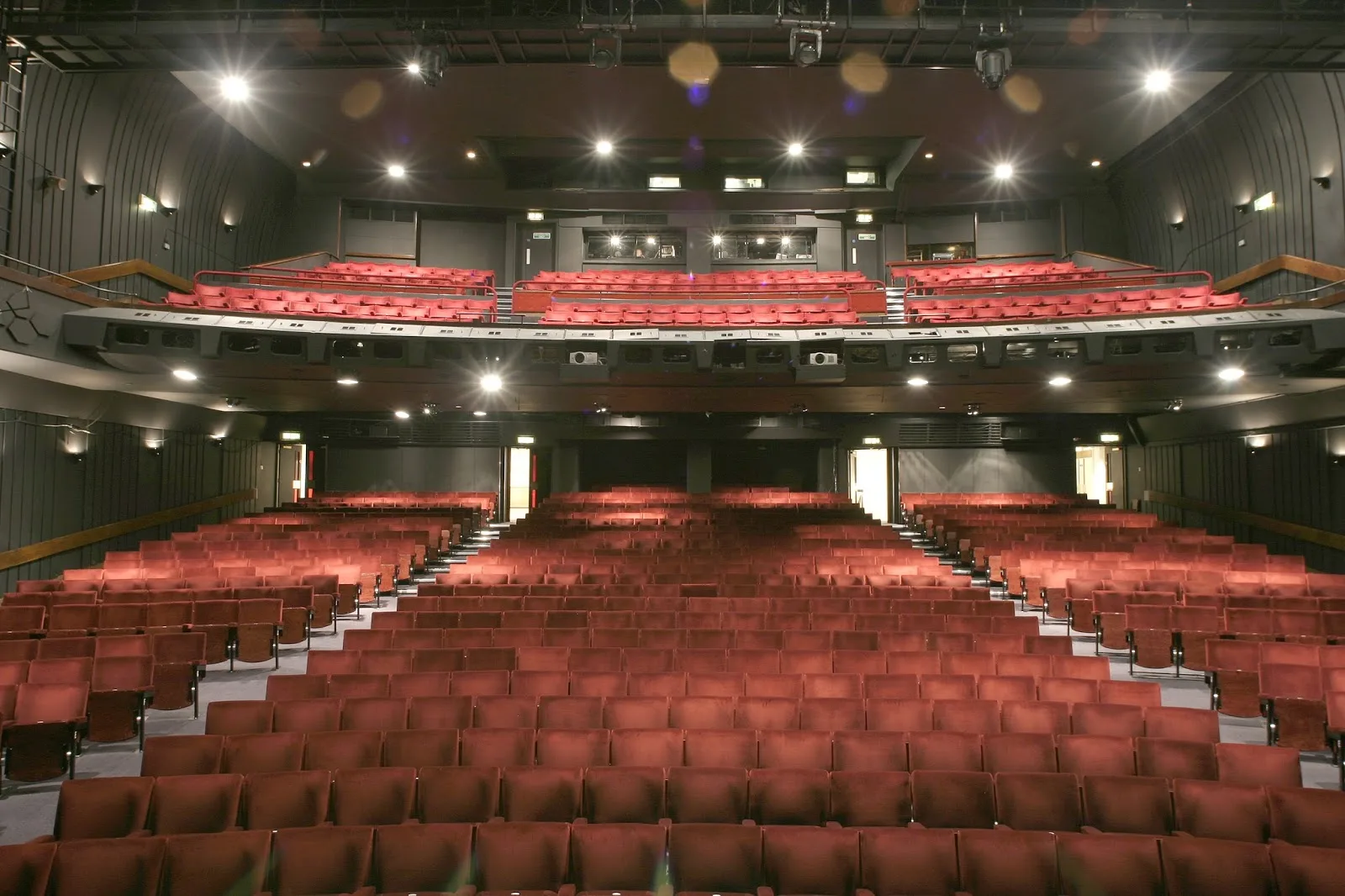 Rows of crimson seats in the stalls and circle of the Peacock Theatre in London, seen from the stage