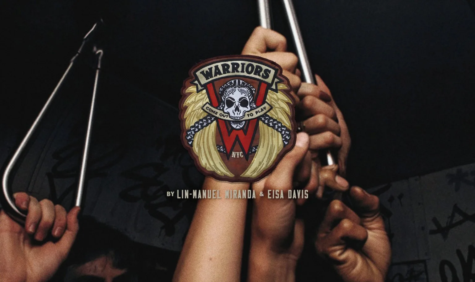Warriors musical artwork: the gang's patch over hands gripping the straps of a crowded New York subway carriage